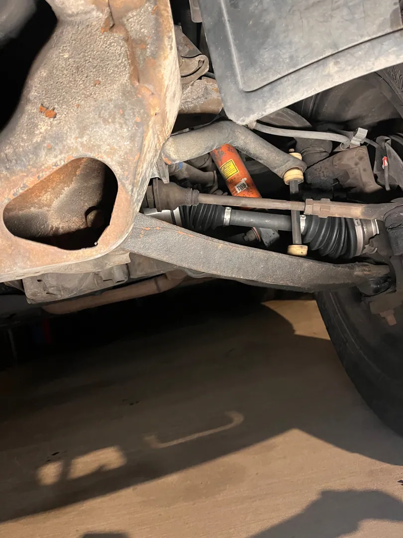 Under a Moreno Valley car on a CV axle job in Moreno Valley, CA