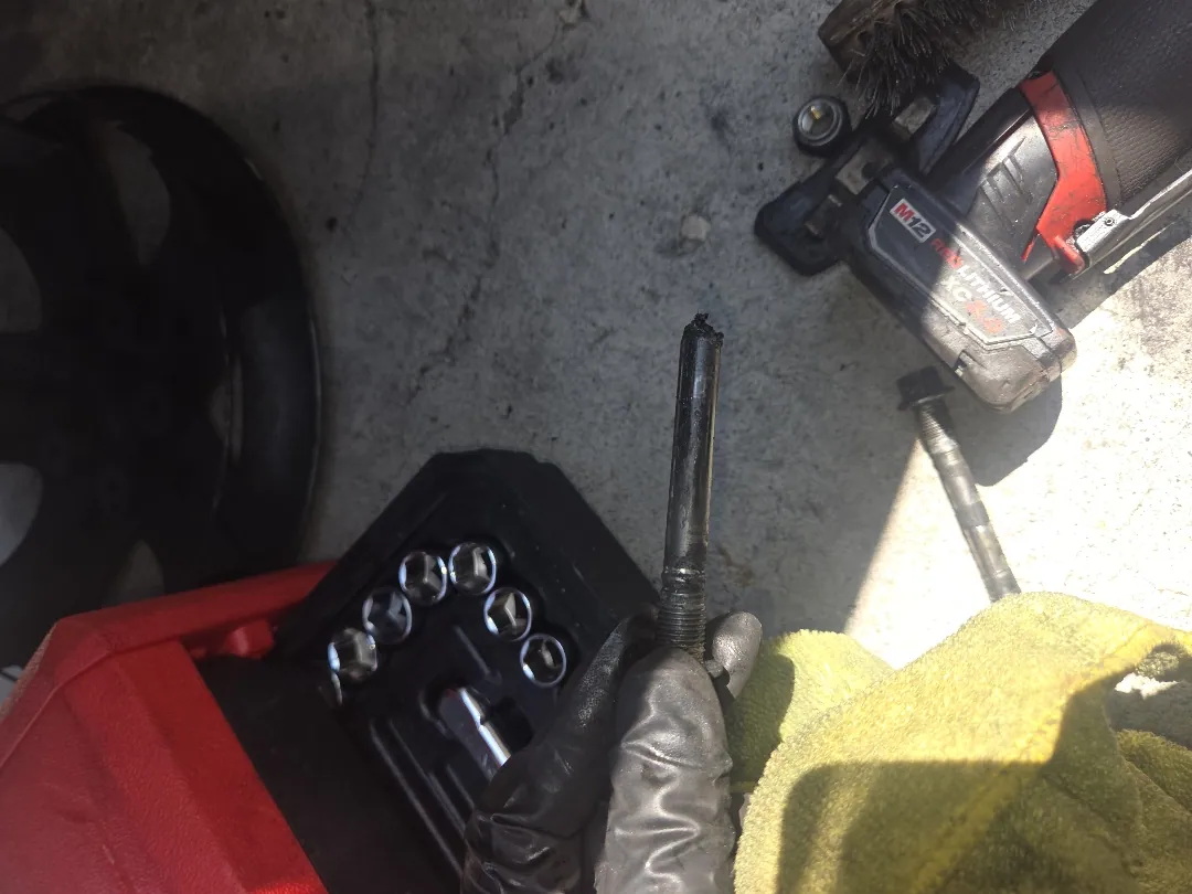 Front brake job in progress — wheel off, sockets and impact gun laid out right where the car was parked — Riverside, CA