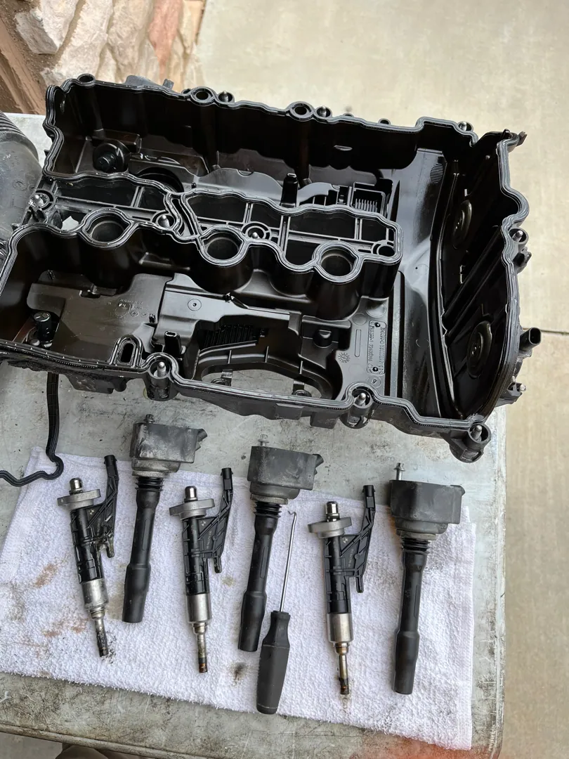 Valve cover off and all four ignition coils pulled and laid out in order so nothing goes back in the wrong hole — Riverside, CA